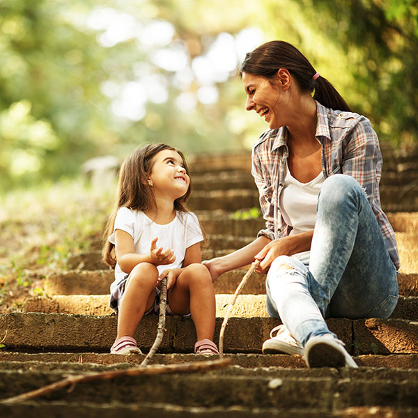 Mother and Daughter sitting on stairs outside